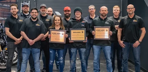 a group of people holding signs - Mosites team posing with Triple BRP Dealer of the Year Awards